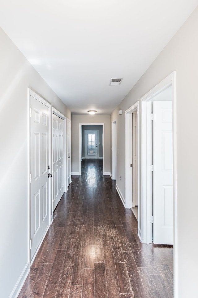 hall with dark wood-type flooring