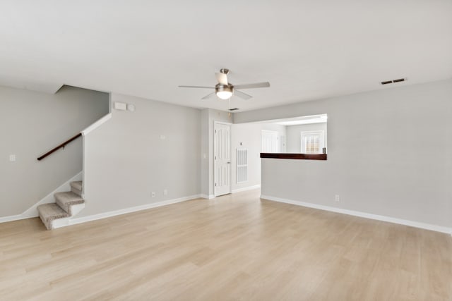 empty room with light hardwood / wood-style floors and ceiling fan