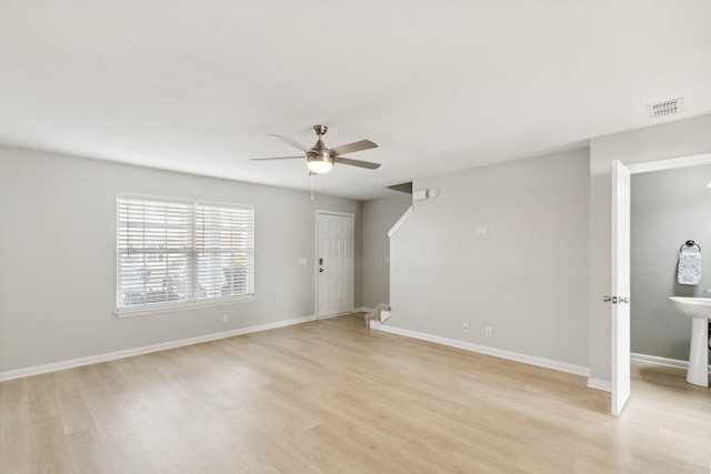 empty room featuring ceiling fan and light hardwood / wood-style floors