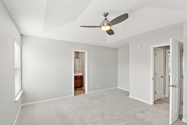 unfurnished bedroom with ensuite bathroom, ceiling fan, and light carpet