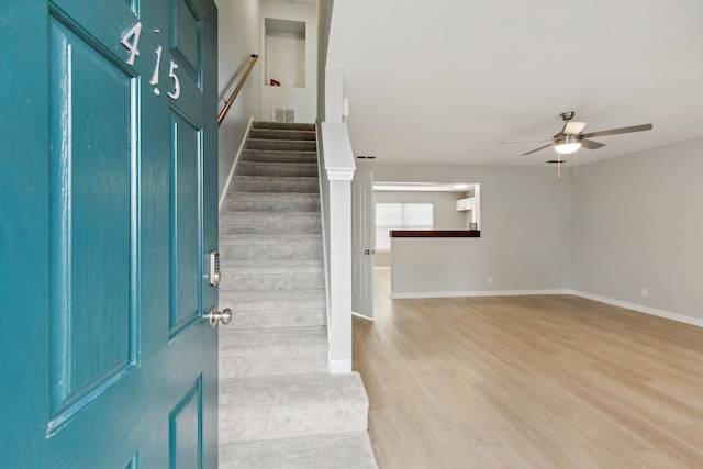 foyer featuring ceiling fan and light wood-type flooring