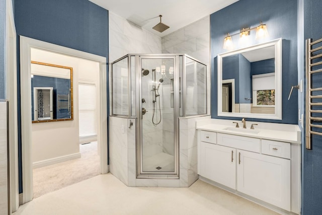 bathroom with walk in shower and vanity