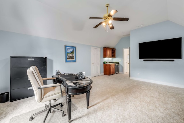 home office featuring lofted ceiling, light carpet, and ceiling fan