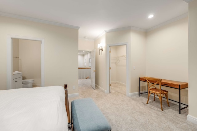 carpeted bedroom with crown molding, a spacious closet, ensuite bath, and a closet