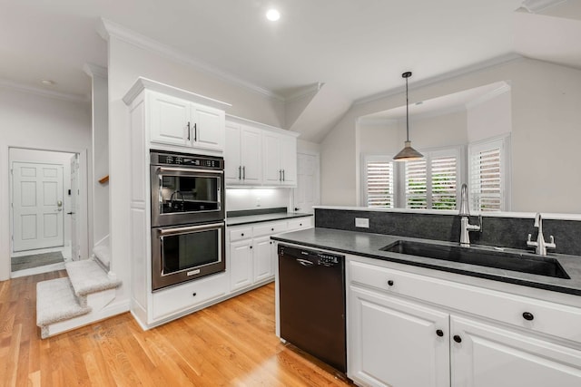 kitchen featuring black dishwasher, white cabinetry, sink, and double oven