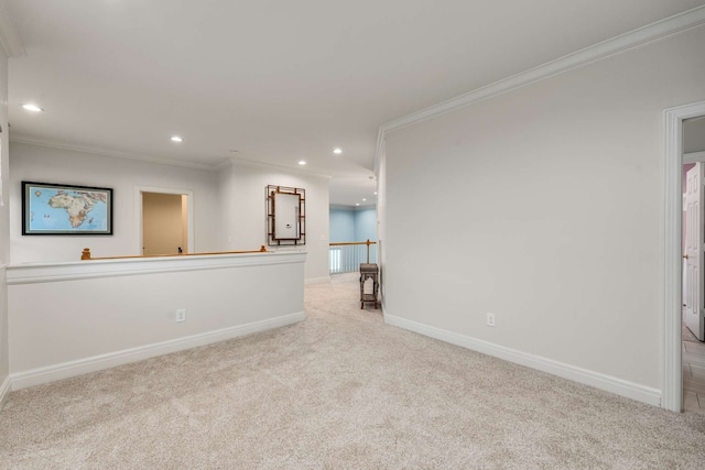 carpeted spare room featuring ornamental molding