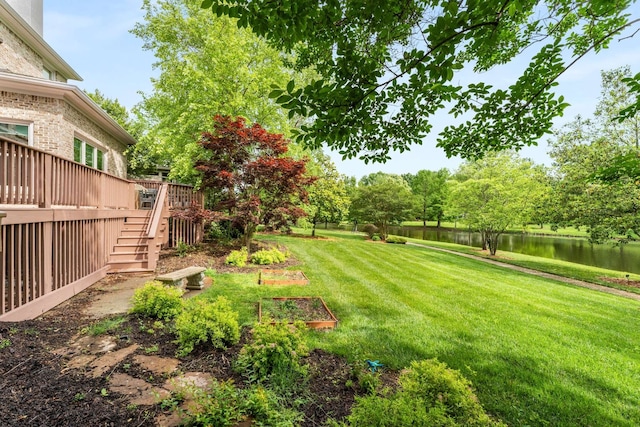 view of yard featuring a deck with water view