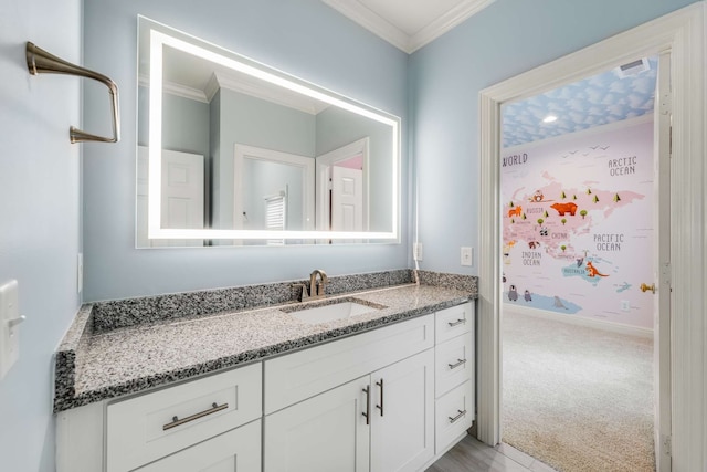 bathroom featuring ornamental molding and vanity