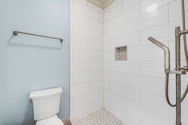 bathroom featuring toilet and tiled shower