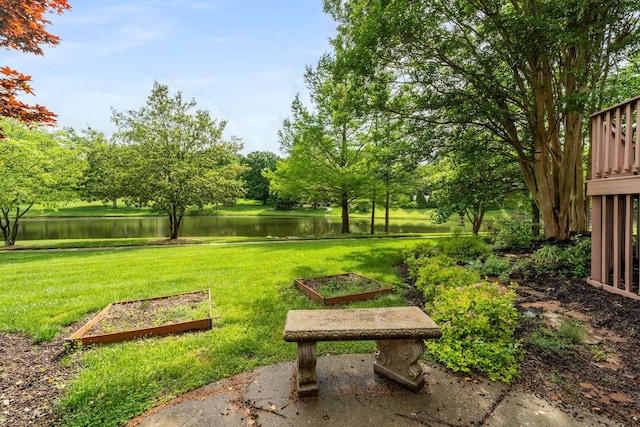 view of home's community featuring a lawn and a water view