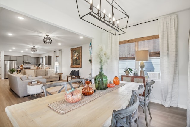 dining area featuring light hardwood / wood-style flooring and a chandelier