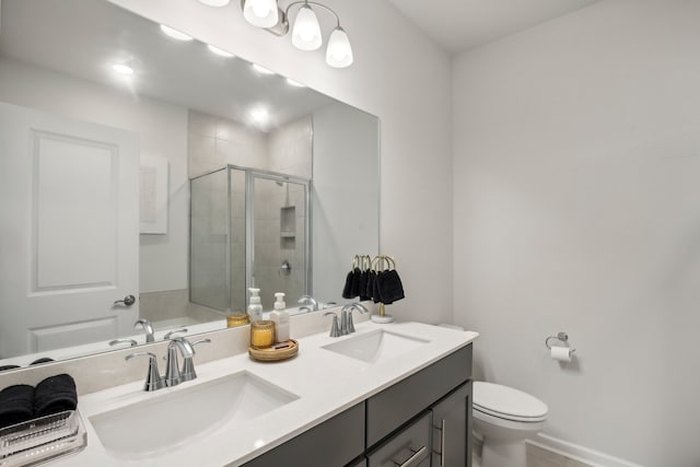 bathroom featuring walk in shower, vanity, and toilet