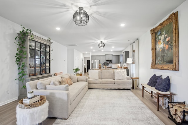 living room featuring hardwood / wood-style flooring and a chandelier