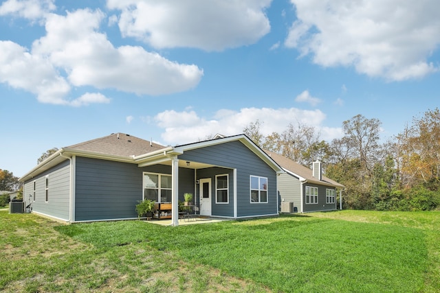 back of property featuring cooling unit, a yard, and a patio area