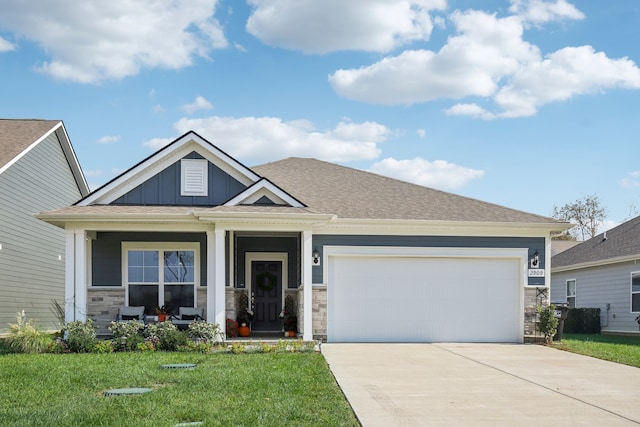 craftsman-style house with a front lawn, a garage, and covered porch