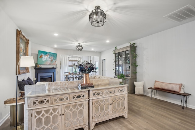 living room with a notable chandelier and hardwood / wood-style flooring