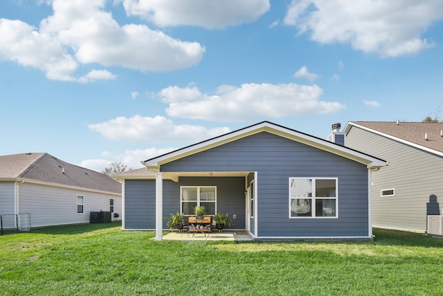 back of property with a yard and a patio area