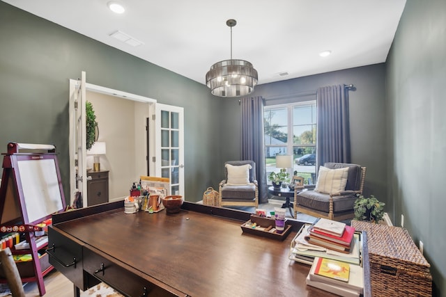 office space featuring wood-type flooring and a notable chandelier