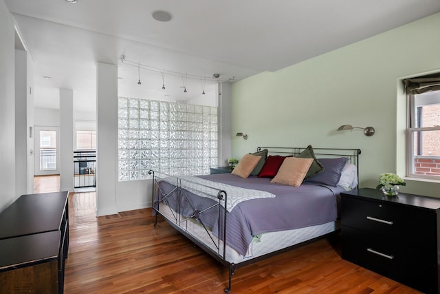 bedroom with dark hardwood / wood-style floors