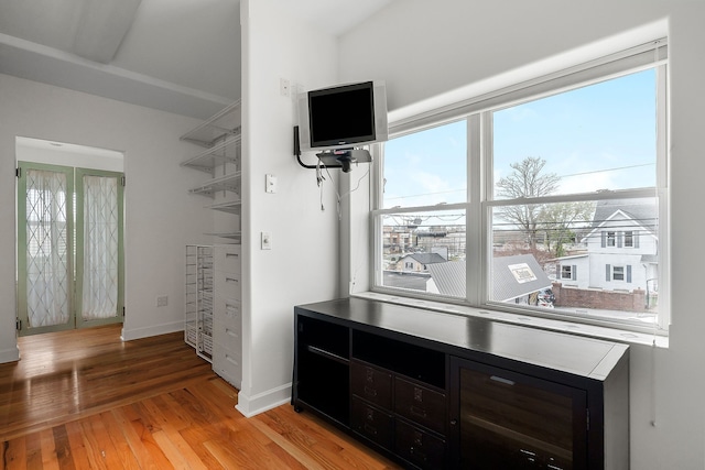 bedroom with multiple windows and light hardwood / wood-style flooring