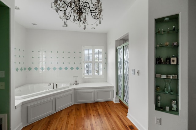 bathroom featuring hardwood / wood-style floors and a bath