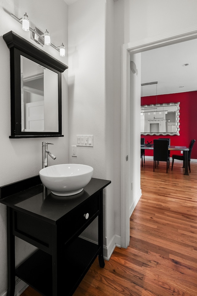 bathroom with vanity and wood-type flooring