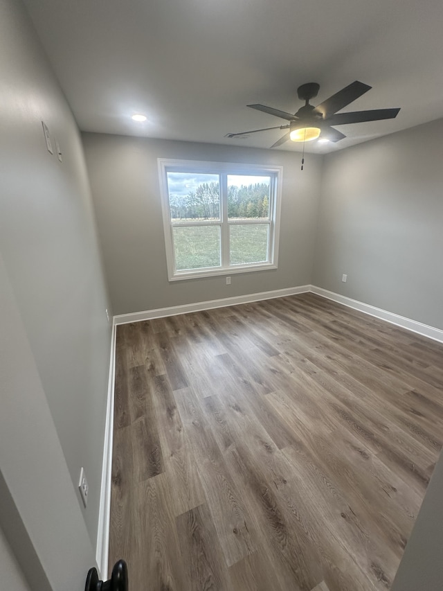 spare room featuring hardwood / wood-style flooring and ceiling fan