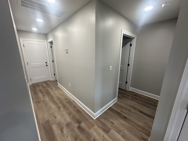 corridor with hardwood / wood-style flooring