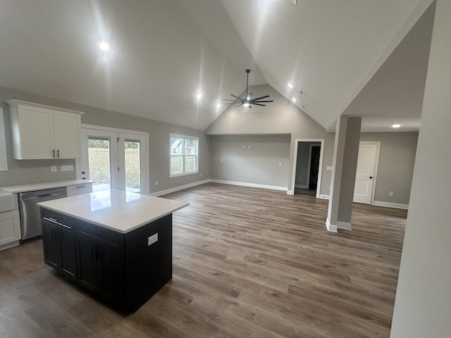 kitchen with a center island, wood-type flooring, stainless steel dishwasher, and white cabinets