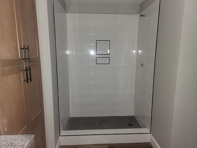 bathroom with a shower with door