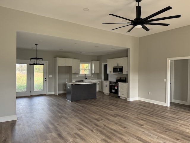 kitchen featuring stainless steel appliances, dark hardwood / wood-style floors, a center island, white cabinets, and pendant lighting