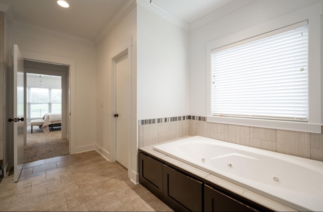 bathroom with a tub and ornamental molding