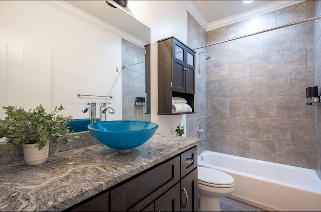 full bathroom featuring crown molding, vanity, tiled shower / bath combo, and toilet