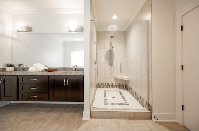 bathroom with crown molding, vanity, and walk in shower