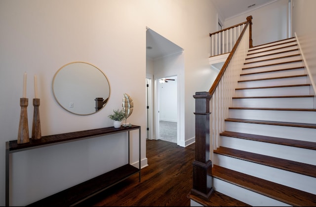 stairs with wood-type flooring, ceiling fan, and crown molding