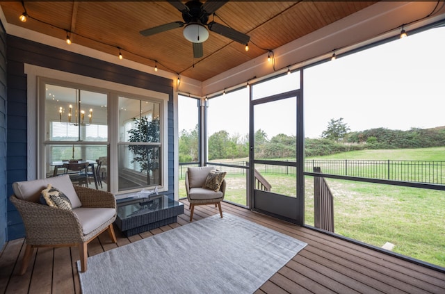 sunroom with ceiling fan and wooden ceiling