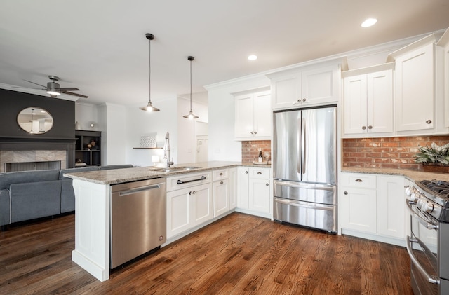 kitchen featuring white cabinets, stainless steel appliances, and light stone countertops