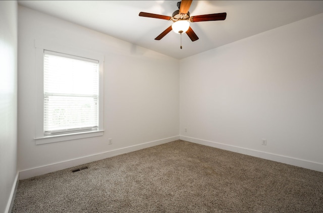 carpeted empty room with plenty of natural light and ceiling fan