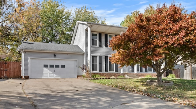 view of front of home with a front lawn and a garage