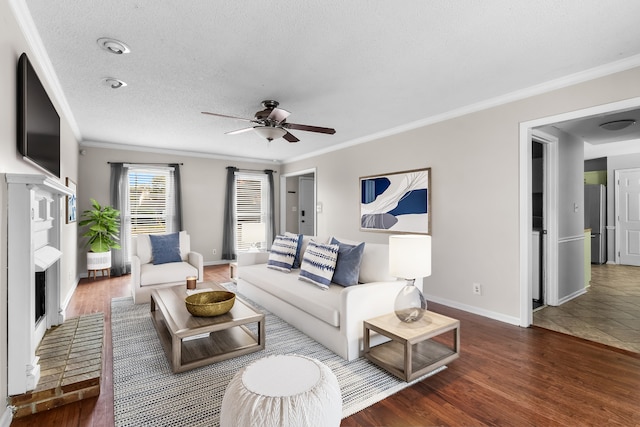 living room featuring dark wood-type flooring, a textured ceiling, crown molding, and ceiling fan