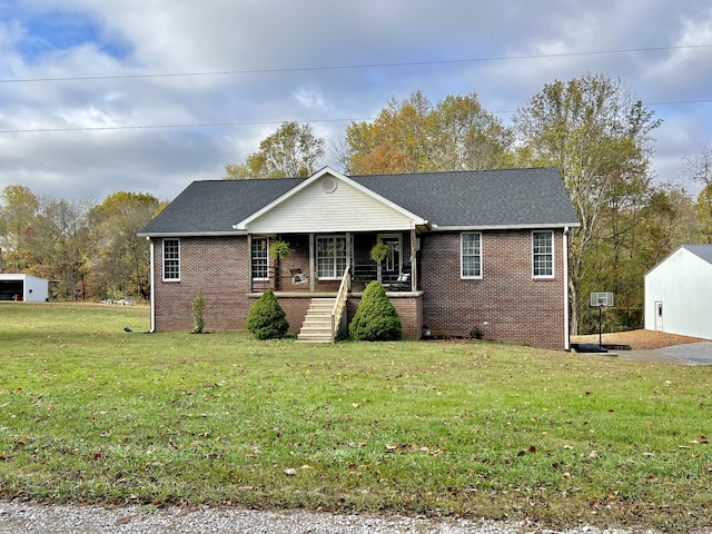 view of front facade with covered porch and a front yard