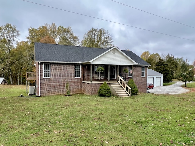 single story home with a garage, an outbuilding, a front yard, and covered porch