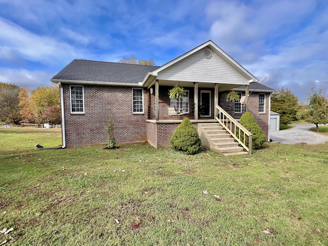 view of front of home with a porch, a garage, and a front lawn