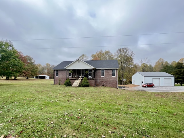 view of front of property with a garage, an outbuilding, a porch, and a front yard