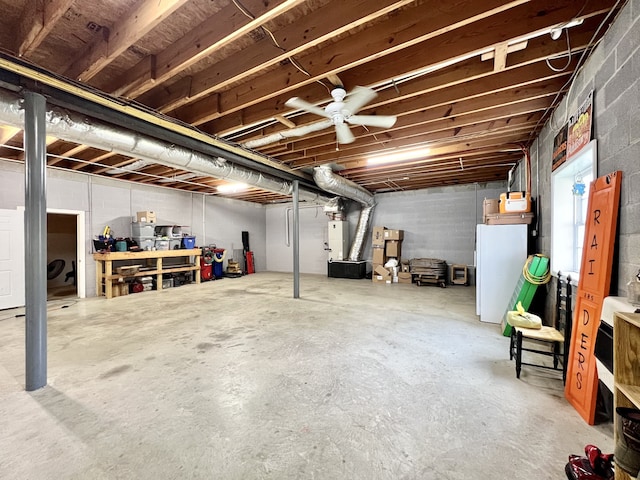 basement featuring ceiling fan and white fridge