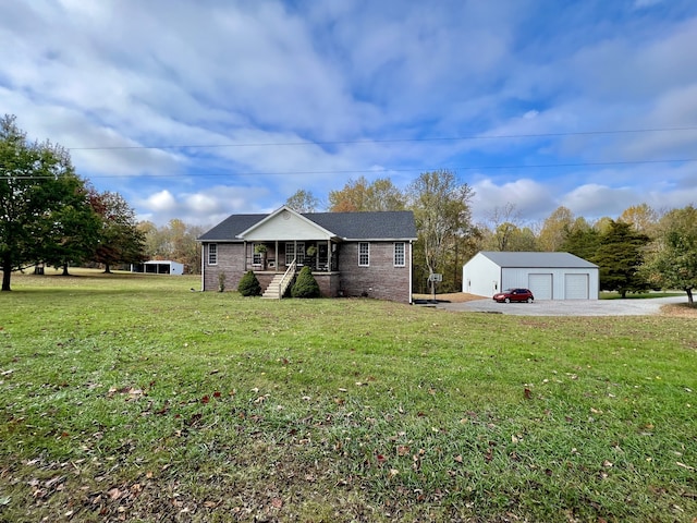 view of front facade featuring an outbuilding, a garage, a front yard, and covered porch