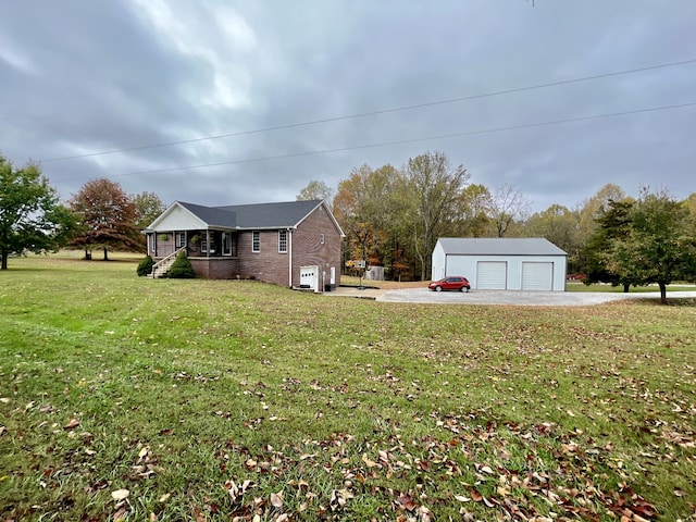 view of yard featuring a garage, an outdoor structure, and covered porch