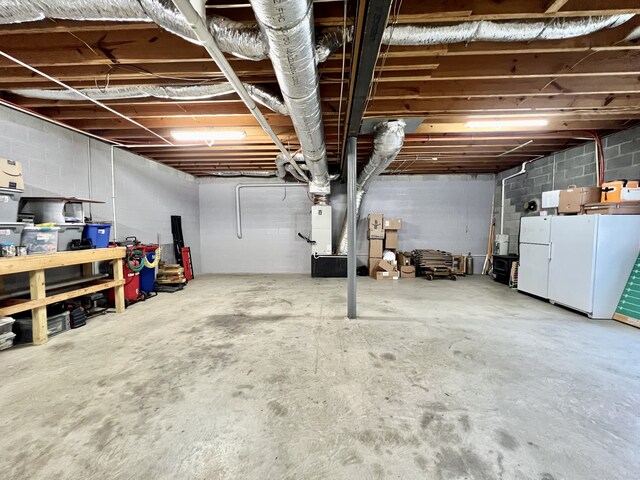 basement featuring white fridge