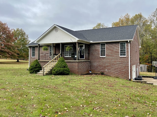 single story home featuring a garage, a front lawn, and covered porch