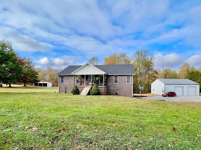 view of front facade with an outbuilding, a garage, a front lawn, and a porch